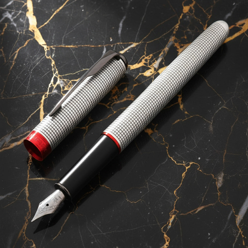 Fountain pen with detailed design on a black and gold marble background