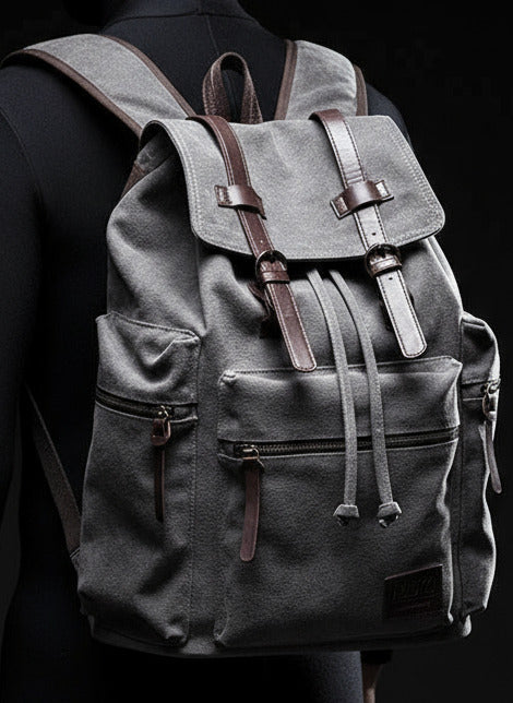 Person wearing a gray backpack against a brick wall.