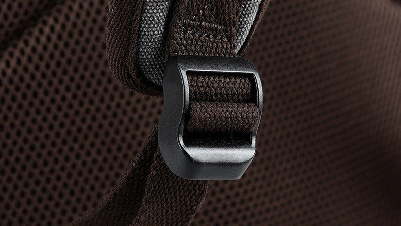 Close-up of a brown backpack with a metal buckle on a white background