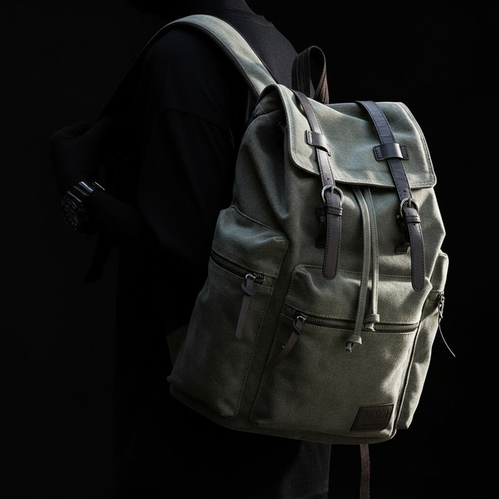 Person wearing a green backpack with a blurred background