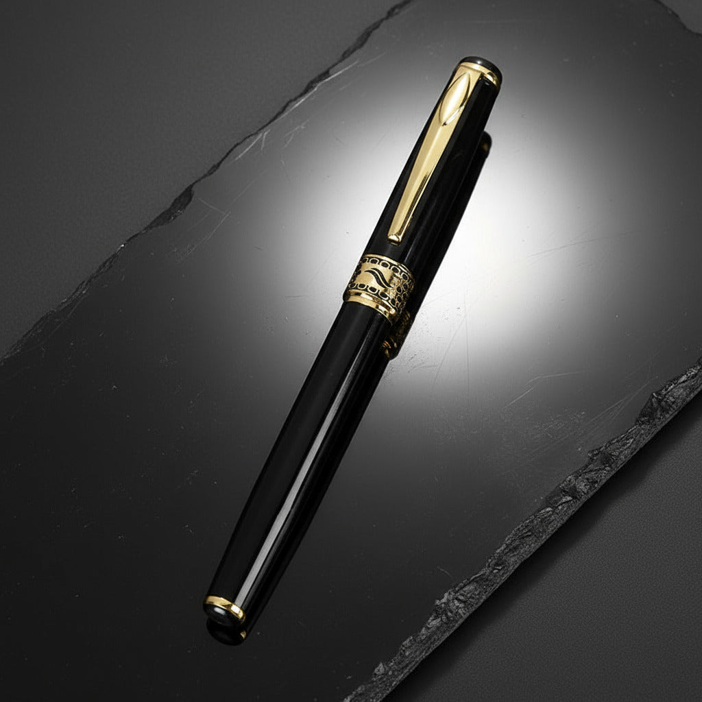 Black and gold pen on a black surface with a blurred background