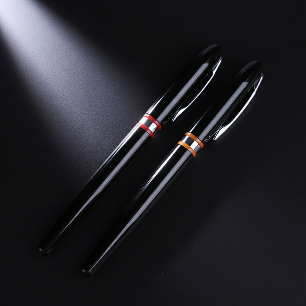 Two black fountain pens with colorful accents on a black surface.